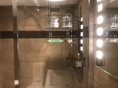 a bathroom with a shower with a glass door at The Waterside Rooms in Annan