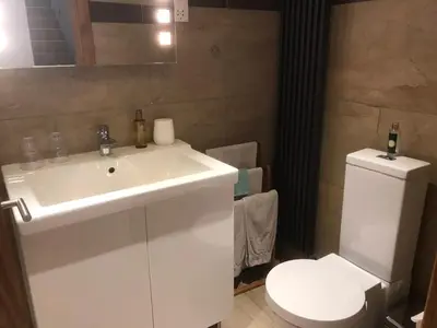 a bathroom with a white sink and a toilet at The Waterside Rooms in Annan