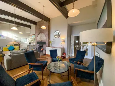 a living room with a couch and chairs and a table at Glaramara Hotel in Borrowdale Valley
