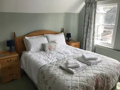 a bedroom with a bed with towels on it at Winchester House in Keswick