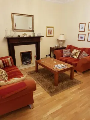a living room with two couches and a coffee table at Hamilton House in Dumfries