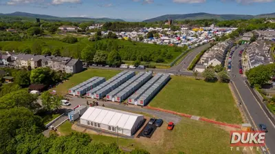 an overhead view of a large building with a road at IOMTT Village at Isle of Man TT in Douglas