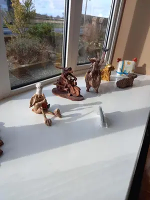 a group of figurines sitting on a window sill at Crossroads House in Carlisle