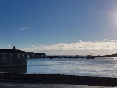 a large body of water with a boat in it at 11 Laigh Isle in Isle of Whithorn