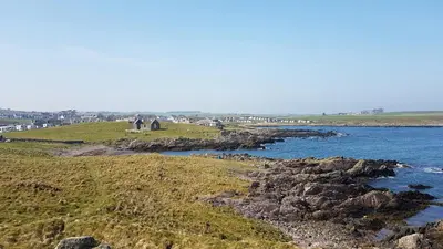 a group of people standing on the rocks near the water at 11 Laigh Isle in Isle of Whithorn