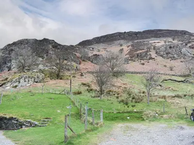 a field with a mountain in the background at Hovera in Glenridding