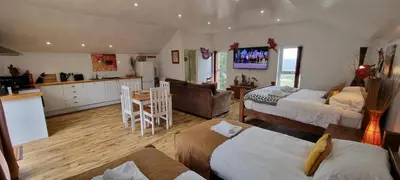 a living room with two beds and a kitchen at Windsor Cottage on The Big 