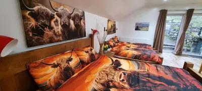 a bedroom with two beds with animals on them at Windsor Cottage on The Big 