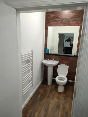 a bathroom with a white toilet and a sink at The Townhouse Self Catering in Dumfries