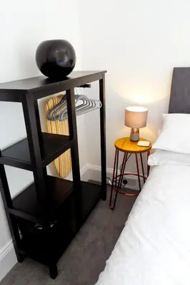 a bedroom with a black desk next to a bed at Rosalind House in Carlisle