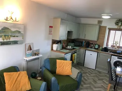 a small kitchen with a couch and chairs in a room at Dove cottage in Allonby