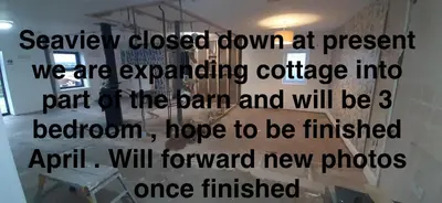 a sign on a wall in a room at Sea view cottage in Allonby