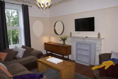 a living room with a couch and a fireplace at Mid Flat in Dumfries