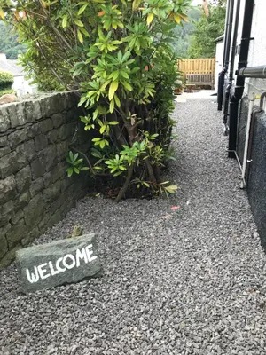 a welcome sign on the ground next to a wall at Claremont House Keswick in Keswick