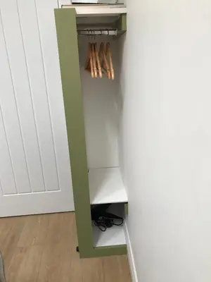 a closet with a green shelf next to a wall at Claremont House Keswick in Keswick