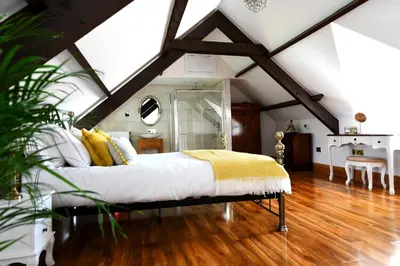 a bedroom with a bed in a attic at Welch House in Douglas