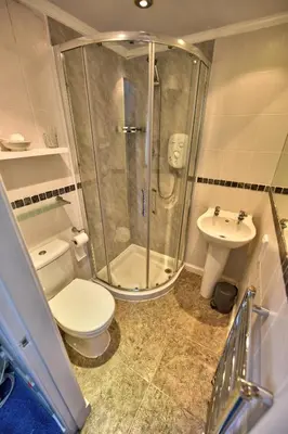 a bathroom with a shower and a toilet and a sink at Burnside Guest House in Ayr
