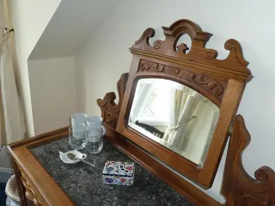a mirror sitting on top of a wooden table at Burnside Guest House in Ayr