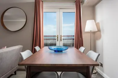 a dining room table with a blue bowl on it at Bay View - Donnini Apartments in Ayr
