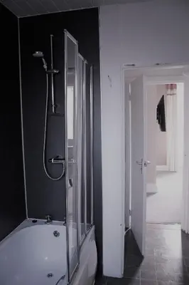 a bathroom with a shower and a white bath tub at The Kirkcudbright Bay Hotel in Kirkcudbright