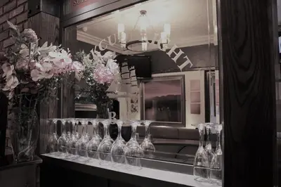 a display of wine glasses in front of a mirror at The Kirkcudbright Bay Hotel in Kirkcudbright