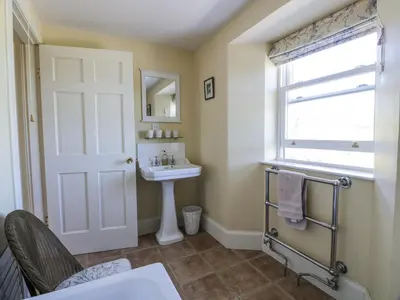 a bathroom with a sink and a mirror at Marl House in Newton Stewart