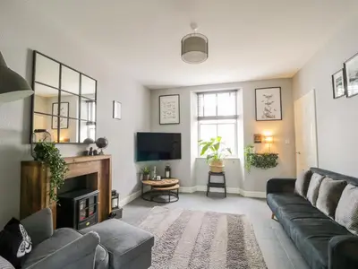 a living room with a couch and a tv at 8 Bridge Street in Cockermouth