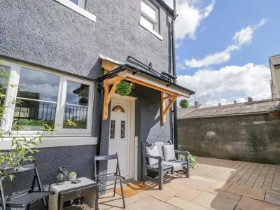 a house with an awning over the front door at 8 Bridge Street in Cockermouth