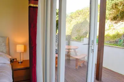 a bedroom with a sliding glass door to a patio at The Fairways in Portpatrick
