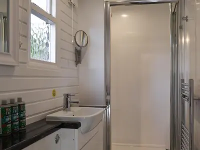a bathroom with a sink and a shower at Field House Lodge in Borrowdale Valley