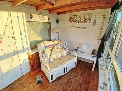 a small room with a couch and a table at Honeysuckle Cottage in Springside