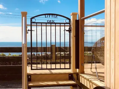 an open door with a view of the ocean at Little Oak - Uk5996 in Carsluith