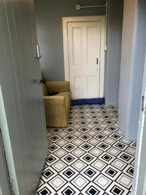 a door leading to a room with a couch and a floor at The Annex, countryside escape in Dumfries