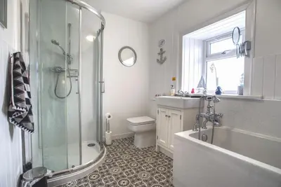 a bathroom with a shower and a toilet and a sink at The View in Garlieston