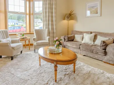 a living room with a couch and a coffee table at Blair Terrace in Portpatrick