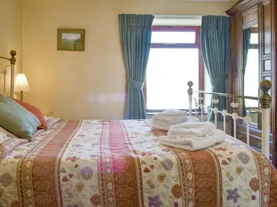 a bedroom with a bed with towels on it at Causey View in Keswick