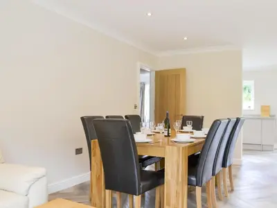 a dining room with a wooden table and black chairs at Lucy's At The Grange - Uk11519 in Mockerkin