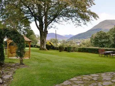 a garden with a gazebo and a tree at Lorna's At The Grange - Uk11565 in Mockerkin