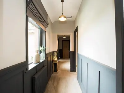 a hallway of a house with a window and a door at Woodend in Maxwelltown