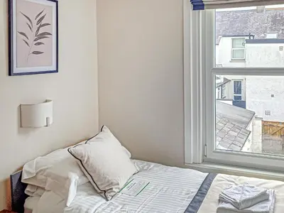 a bedroom with a bed and a window at Wanderers Rest in Keswick