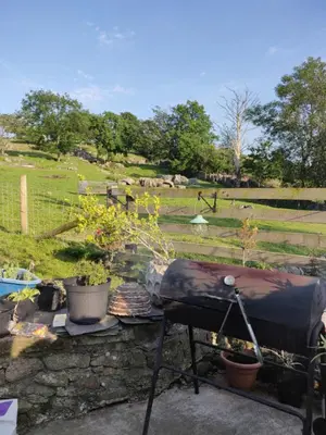 a grill sitting on top of a stone wall at Row Farm Cottage in Millom