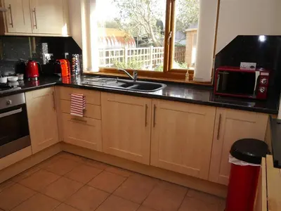 a kitchen with a sink and a microwave at Number 48 in Dumfries