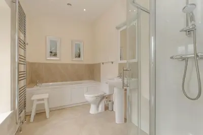 a bathroom with a toilet and a sink and a shower at Pant Farmhouse in Ayr