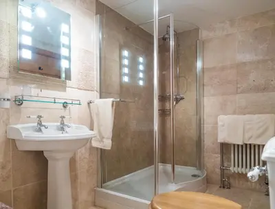 a bathroom with a shower and a sink and a toilet at The Wayside and Whisky Barn in Whitbeck