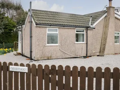 a house with a fence in front of it at Mardan in Dumfries