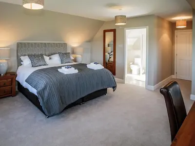 a bedroom with a bed with two towels on it at Corsewall Castle Farm Lodges in Stranraer