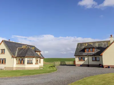 two houses on a gravel road at Corsewall Castle Farm Lodges in Stranraer