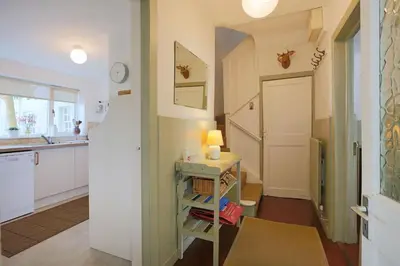 a kitchen with a table with a lamp on it at 57 High Street in Kirkcudbright