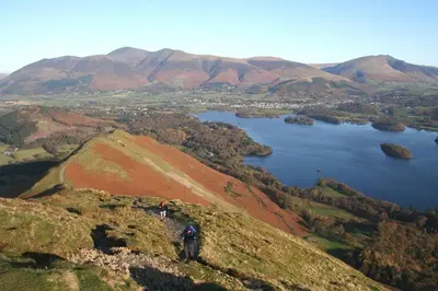 two people standing on top of a hill with a lake at Tithe Cottage in Keswick
