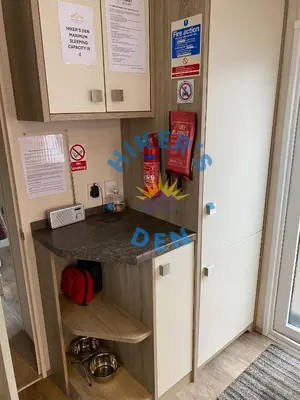 a kitchen with a counter and a refrigerator at Hikers Den, Brigham, Cockermouth, Cumbria in Cockermouth